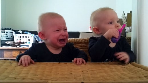 Super Adorable Twins fighting over a toothbrush