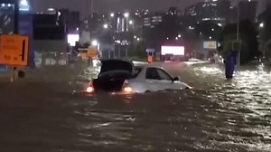 Three people have died and at least one is missing after record levels of rainfall triggered flash floods and landslides in New Zealand’s largest city, Auckland.