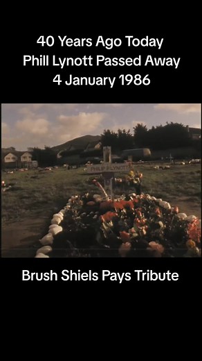 Brush Shiels visits the grave of his friend Phil Lynott at St Fintan's Cemetery in Sutton, Dublin. Marking the first anniversary of the death of Irish rock singer Phil Lynott, his friend the musician Brush Shiels visits St Fintan's Cemetery in Sutton, County Dublin. Phil Lynott died in England on 4 January 1986. Seven days later he was laid to rest at St Fintan's Cemetery. At the graveside Brush Shiels salutes his old pal, Hey amigo, how’s it going man? He wishes the weather was warmer for his g