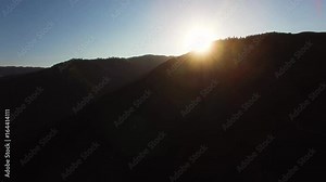 Aerial view of a sunrise over a California mountain early in the morning.