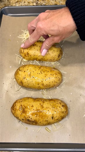 Eating Healthy Today on Instagram: "CRISPY BAKED POTATO HALVES! (Via: @mimis.kitchen__) INGREDIENTS: * 2 large Russet Potatoes * 1 - 1 1/2 tablespoons olive oil * 2 tablespoons salted butter * 1/4 -1/3 cup shredded Parmesan * Kosher salt * Ground black pepper * Grated cheddar cheese * Chopped scallions and chives * (Can also add chopped cooked bacon or other toppings) DIRECTIONS: * Preheat oven to 425° . Line half baker sheet with parchment paper. * Scrub potatoes as well to get them nice and cl