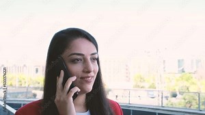 Woman talking phone, profile side footage of brown haired woman talking phone. Businesswoman talking with client or friend and smiling. Keeping a conversation with the mobile phone with someone.
