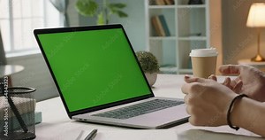 Hands of man at chroma key green screen laptop computer gesturing during an online video conferene with employees or customer - distant work, technology concept 4k template