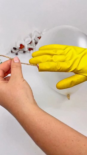 I learned this beautiful craft from my grandma. #handmade #twinecrafts #decor #diyhomedecor #diy #twine #ideakreatif #ideacraft Materials: rubber glove, water, glue, brush, balloon, thread, hot glue gun, scissors, lace ribbon, wire, cardboard tube, jute twine, wooden stand, white filler, decorative chicks, stones, flowers, greenery. | FastDIY