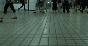 Footsteps of commuters through a busy subway station.