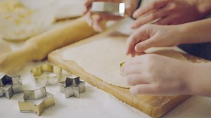 Close up of the Caucasian woman's and child's hands making forms from the daugh on the kitchen table. Indoors | Free Stock Video Footage
