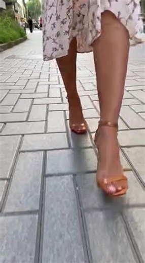 The girl is walking on the road wearing high-heeled sandals #foot #stockings #sandals