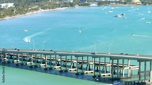 Aerial tracking drone video car traveling on a bridge causeway Miami