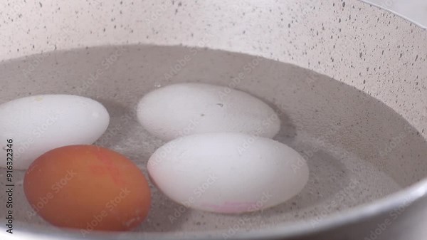 Boiled eggs in a saucepan on ceramic hob