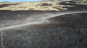 Chain of Craters Road in Hawaii Volcanoes National Park is vivid with blue ocean, waves and black sea cliffs. Cliffs were formed when Mauna Ulu exploded liquid lava.