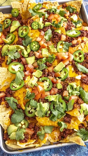 My famous loaded nachos recipe with tortilla chips, salsa con queso, shredded cheddar, spicy chorizo, jalapenos, fresh avocado, and tomato, a party favorite! My friends can't get enough of these late night nachos. >> Comment “RECIPE" and I'll send this recipe straight to your DMs! 🥳 GET THE FULL RECIPE ⬇️ https://www.chilipeppermadness.com/chili-pepper-recipes/appetizers/the-original-mike-s-late-night-nachos/ Ingredients: 1 14 ounce bag corn tortilla chips 1 15 ounce jar salsa con queso 4-6 oun