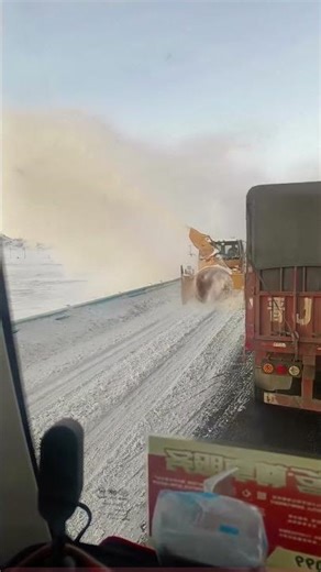 Snow Chase: A Snow Plow Works Alongside a Truck