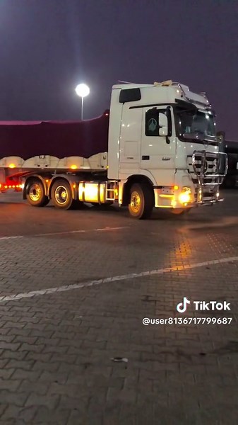 Large White Semi-Truck in Nighttime Parking Scene