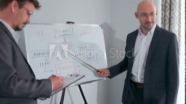business strategy discussion, managers review marketing flowchart, consultant and manager analyze strategy diagram together, two professionals collaboratively discussing marketing strategy and success