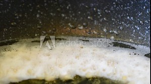 Popcorn is boiled in hot boiling vegetable oil, explodes and shoots up when opened, exuding the fragrant smell of fried corn Stock Video