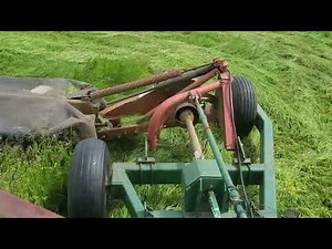 IH 1066 cutting hay with a Disc mower caddy