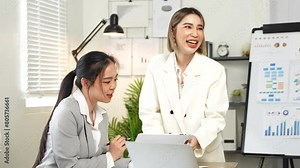 Asian business women Talk about new projects, presents at home office.
