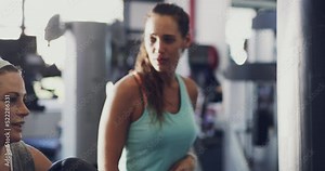 Boxer, athlete and fighter boxing, training and exercising at gym with a punching bag and working out with her coach or personal trainer. Chubby, plus size and overweight woman practicing for a fight