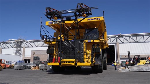 Massive mining truck maneuvered at industry expo