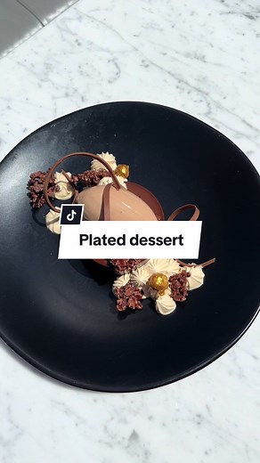 🔙 to this stunning plated dessert by #ValrhonaCercleV Chef Toni Roberts featuring flavors from CARAÏBE 66%, nibs, praline paste, Gianduja mousse and chocolate decor ❤️ #Valrhona #valrhonausa #pastry #pastrychef #chocolatier #chocolate #dessert #chef #chocolatemousse #chocolatelover #chocolatedecor #chicagochef