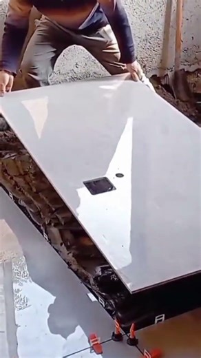 The process of installing a ceramic on the building floor by a handyman neatly