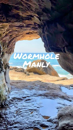 Pete & Nic | Travelling Together, Exploring Forever on Instagram: "The Wormhole, Manly NSW 🪄 Hidden at the northern end of Manly Beach, this short tunnel connects Manly to Queenscliff — carved through the rock by local fishermen over 100 years ago. Step through for sweeping coastal views and that wild Northern Beaches energy 🌊 After soaking it all in, head back to Manly for a dip in Queenscliff ocean pool 🏊‍♂️ ⚠️ Use caution — the rocks can be slippery and the tunnel is only safely accessible