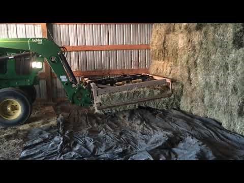 Stacking hay with grapple