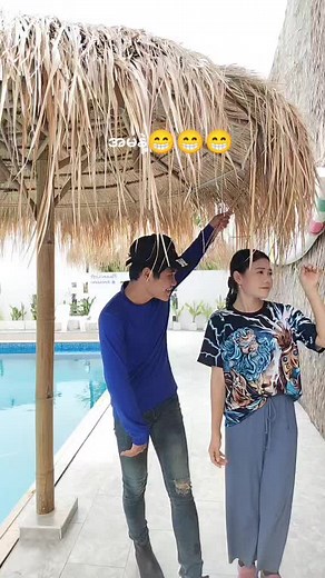 Playful Poolside Interaction Between Friends