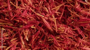 Dried crimson saffron on grey desk close-up macro. Orange red spice for food. Crocus sativus flower saffron