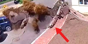 Watch the moment a high-pressure water pipe explodes leaving a six-square-metre hole in the ground