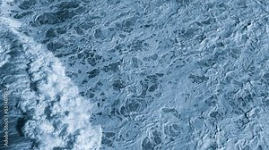 Beautiful aerial drone view on huge Atlantic ocean waves. 4K resolution top view video of stormy sea or ocean toned in navy blue