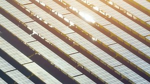 The photovoltaic power station gleams with solar panels capturing the sun's energy, generating clean electricity under the brilliant daylight. Renewable energy and Carbon footprint reduction concept.