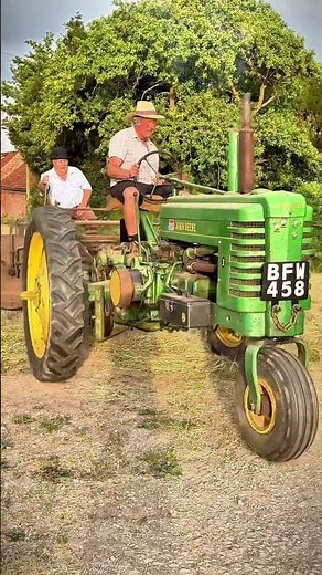 John Deere model B with rake