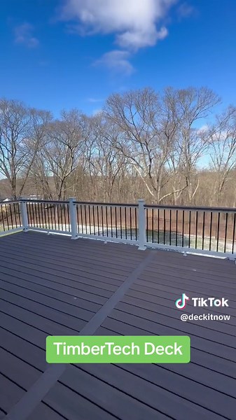 Check out this new backyard deck we just wrapped up in Hopkinton, MA! This deck features TimberTech Vintage English Walnut deck boards in a picture-framed design, paired with Trex Select white composite railings with black aluminum balusters. #deckcompany #deckbuilding #timbertech #timbertechdecking #deckdesign #composite #compositedecking #massachusetts #backyarddeck