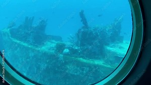 Aruba: View from viewing portals on Atlantis VI Submarine. Canadian passenger submarine company. Interior of the tourist submarine Atlantis whilst submerged. Sunken ship makes coral reef.