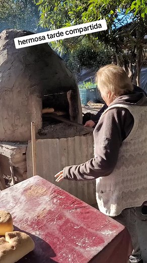 Elderly Woman Baking Bread in Rustic Outdoor Setting
