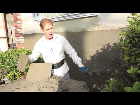 Spread stucco using a stucco hawk and trowel