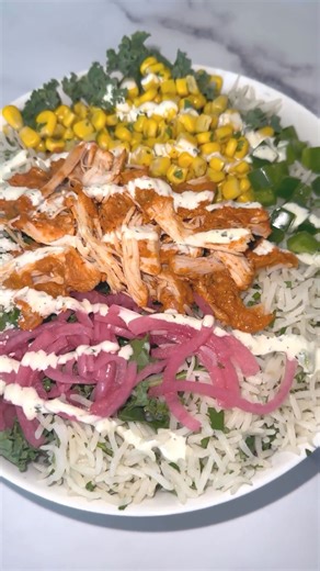 The Chicken Tinga Zeppelin and Bowl are back! This warm and hearty meal is full of saucy tinga chicken, cilantro basmati rice, pickled red onions, corn salad, jalapenos, cotija cheese, and kale. | Bread Zeppelin