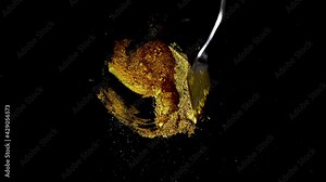 Mixing golden sparkling powder. Satisfying process of creating watercolor paint using palette knife and pigments on black background. Inventing new colors, creative process, artistic approaches.