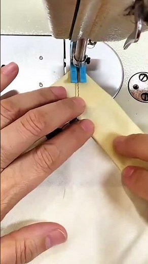 stitching colorful fabric pieces together using a professional sewing machine with blue thread