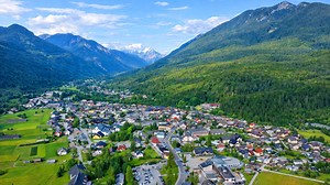 A mountain town surrounded by forest and peaks