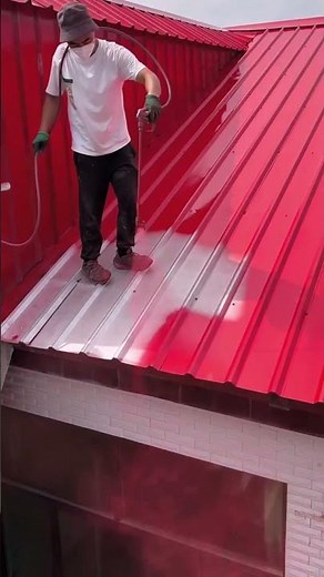 The process of painting a metal roof with a spray gun