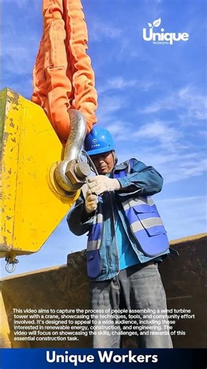 Wind turbine assembly: people assembling a wind turbine tower with a crane