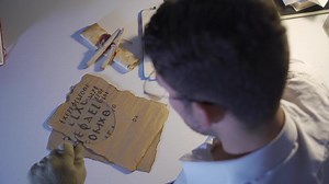 The historical letter written in medieval letters is being examined by the inscription scientist. Epigraphist who researched and translated medieval letters for communication.