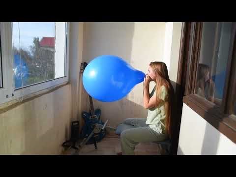 Cute girl Ilka blow to pop 18 inch blue balloon