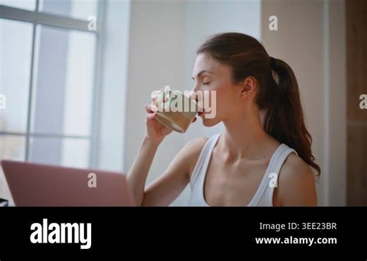 Woman browsing laptop early morning sitting comfortable home closeup. Relaxed young lady watching computer reading online message relaxing cozy light bedroom. Calm student resting alone at apartment Stock Video Footage - Alamy