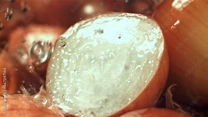 Water drips onto the cut half of the onion. Filmed on a high-speed camera at 1000 fps. High quality FullHD footage