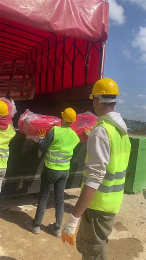 Construction Workers Loading Materials on Site