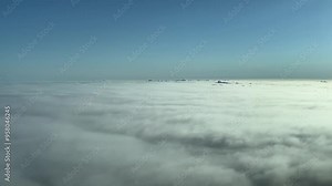 Immersive pilot POV flying over a sea of clouds after sunrise. Aerial footage taken from an airplane cockpit. 4K