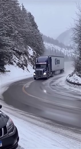 Icy Curve Sends Semi Truck Over the Edge on Snowy Highway ❄️ Loveland Pass, Colorado — Winter 2025 A routine winter drive turns catastrophic when a semi-truck loses traction while navigating a sharp curve on a snow-covered mountain pass. Shaky bystander footage shows the truck sliding into the guardrail, which fails on impact, sending the tractor-trailer crashing down a steep embankment below. Snow and debris cascade through the trees as onlookers gasp at the sudden collapse. Officials reminded 